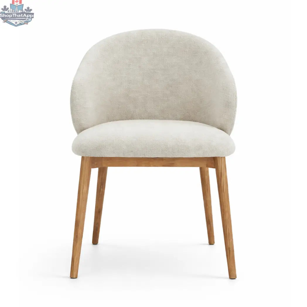 Hygge Design House Alda dining chair with wooden legs and upholstered seat in a modern, stylish dining room setting.