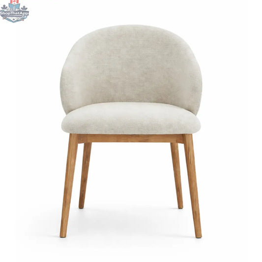 Hygge Design House Alda dining chair with wooden legs and upholstered seat in a modern, stylish dining room setting.