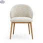 Hygge Design House Alda dining chair with wooden legs and upholstered seat in a modern, stylish dining room setting.