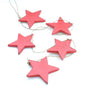 String of five hanging wooden star decorations for home decor by Suzie Blue Canada, featuring rustic star shapes on a string.