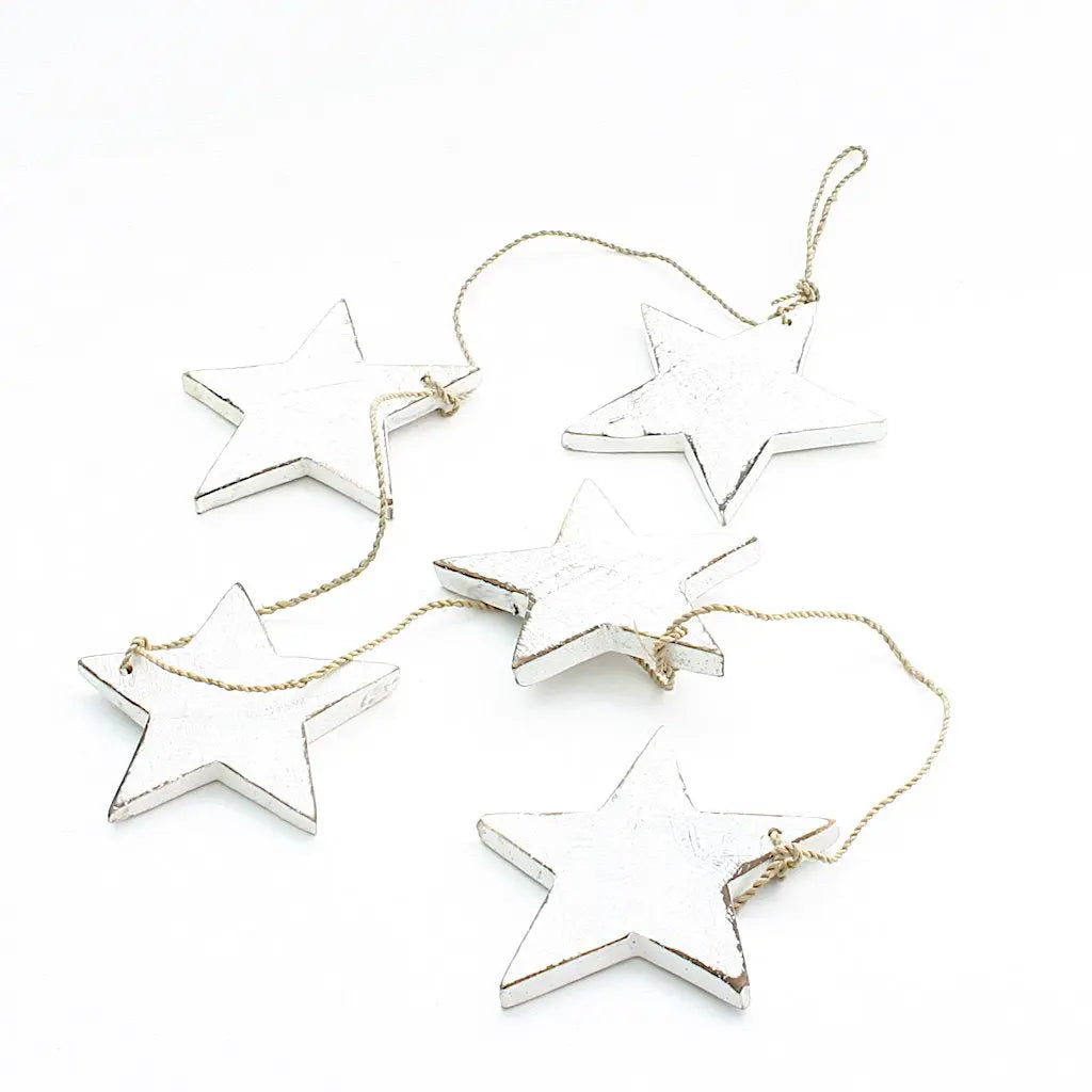 String of five hanging wooden star decor pieces from Suzie Blue Canada, ideal for home decoration and wall display.