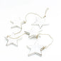 String of five hanging wooden star decor pieces from Suzie Blue Canada, ideal for home decoration and wall display.