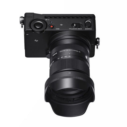 Sony E-mount 18-50mm F2.8 DC DN Contemporary lens in black, showing the compact zoom lens with lens cap attached.