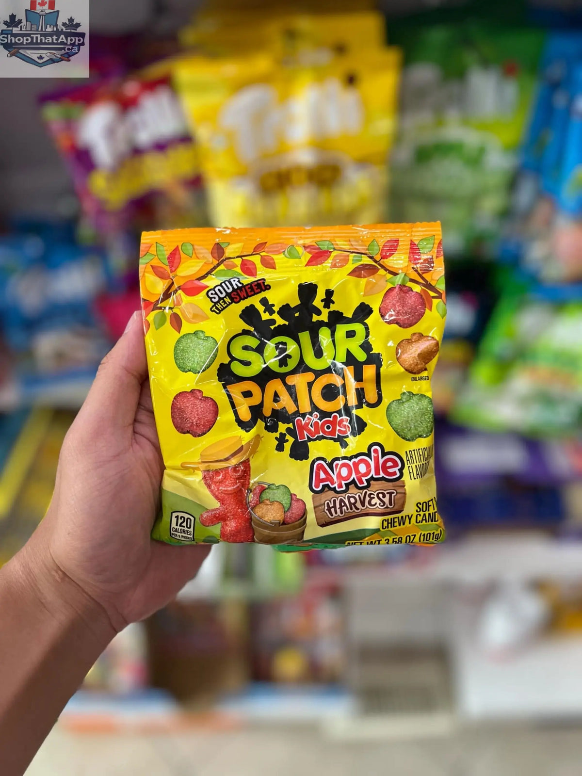 Assorted Sour Patch Kids Apple Harvest candies in a 101g Snack Bar Co package, colorful fruit-flavored chewy candies.