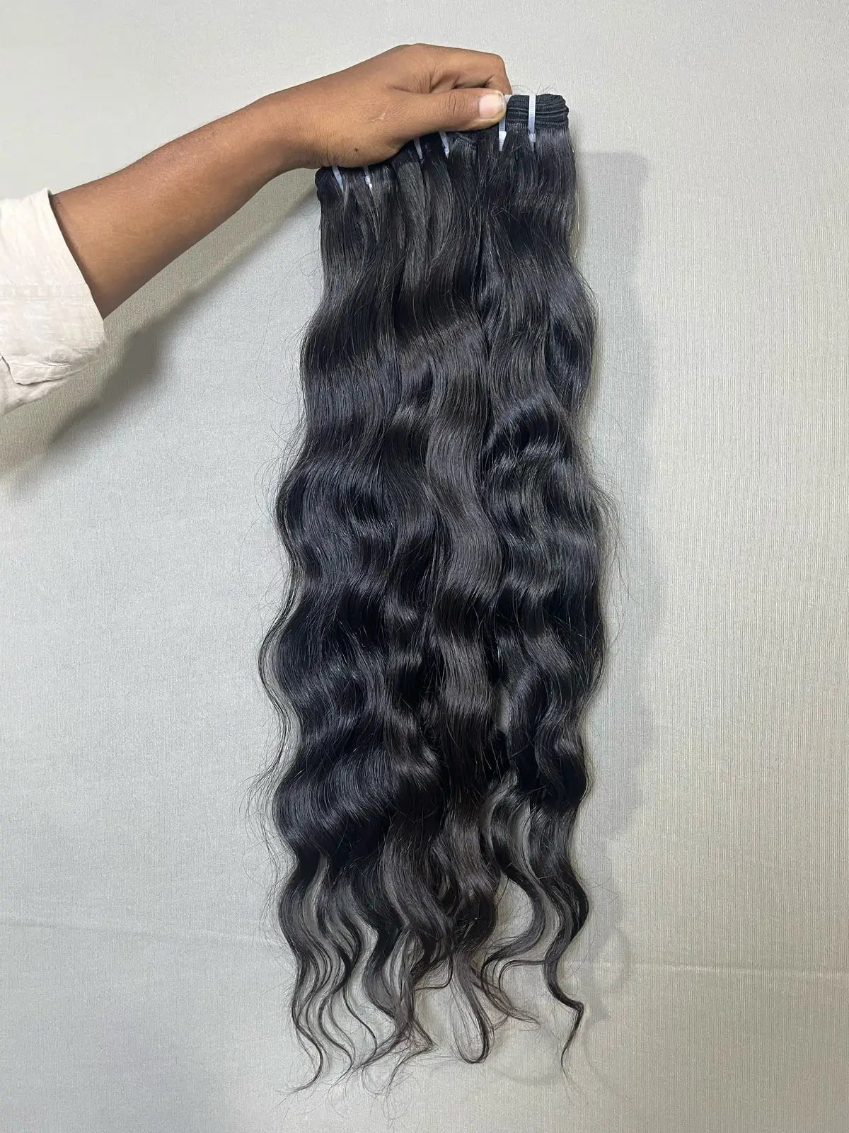Indian raw wavy hair bundles from Prithvi Mart, showcasing natural, textured wavy hair extensions for a full, voluminous look.