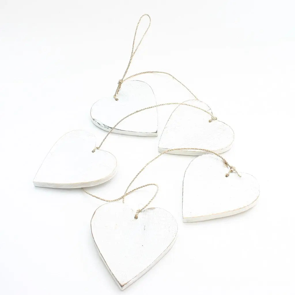 Set of five hanging wooden heart string decor pieces by Suzie Blue Canada, natural wood finish for charming home decor.