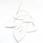 Set of five hanging wooden heart string decor pieces by Suzie Blue Canada, natural wood finish for charming home decor.