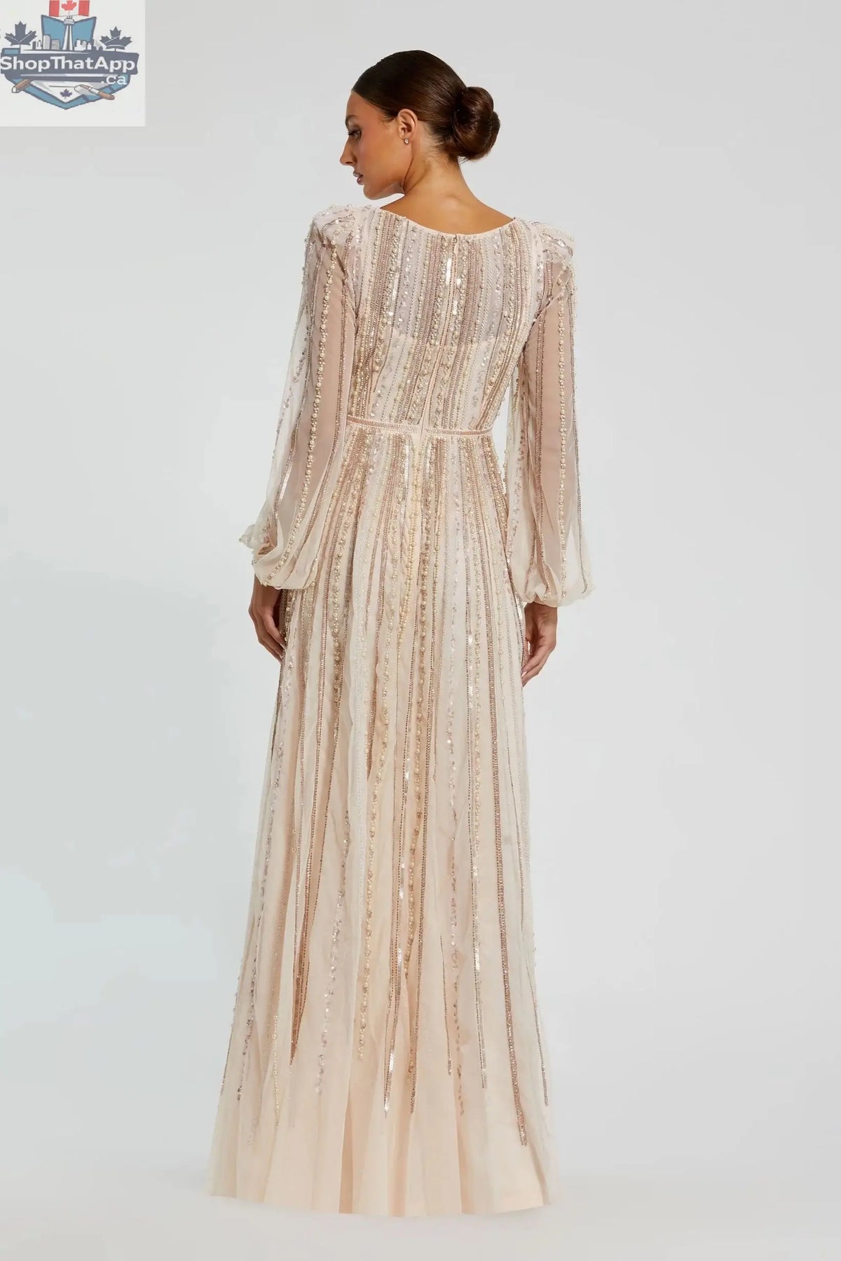 Elegant Threads peach boat neck long sleeve evening gown with striped beading, showcasing a flowing silhouette and intricate detailing.