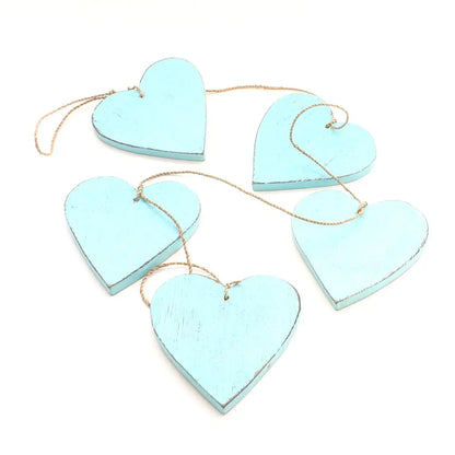Set of five hanging wooden heart strings for home decor, featuring natural wooden hearts with rustic charm by Suzie Blue Canada.