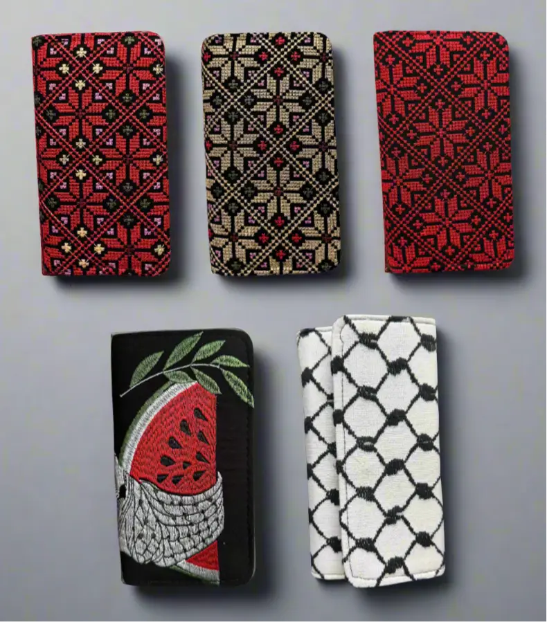 Handheld large Palestinian wallet by The Olive Tree in red, gold, watermelon, or kufiya pattern, featuring traditional design and vibrant colors.