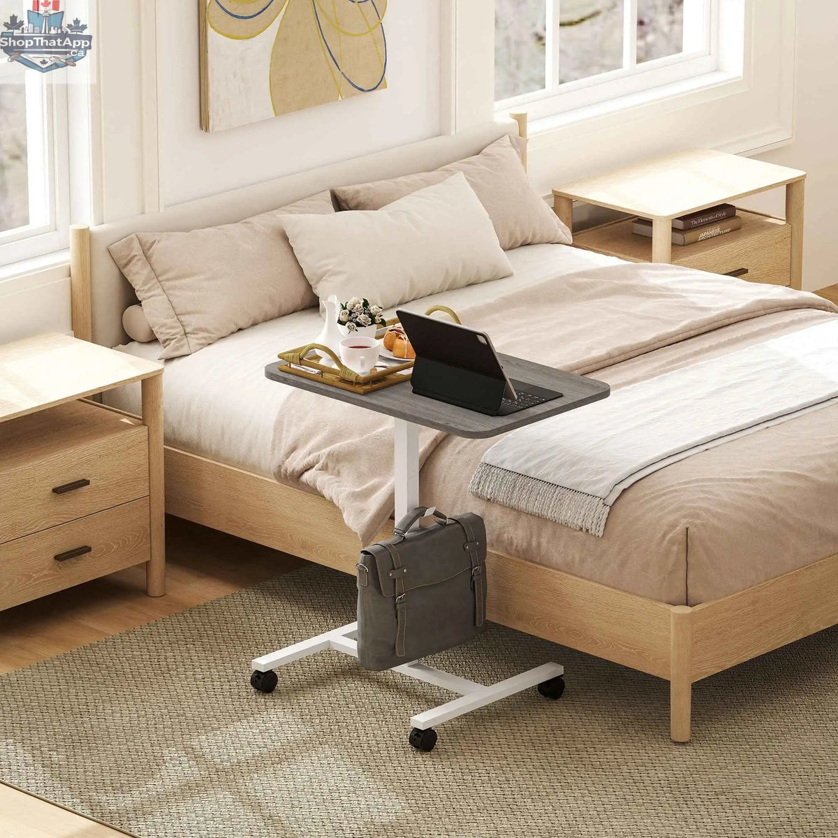 Grey Eden height adjustable office desk with wheels and headphone hook by SLOTH Nation, showing the desk's sleek design and mobility features.