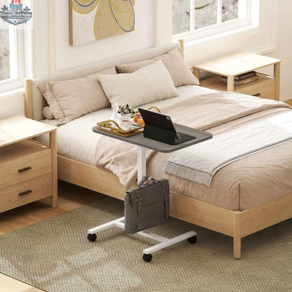 Grey Eden height adjustable office desk with wheels and headphone hook by SLOTH Nation, showing the desk's sleek design and mobility features.