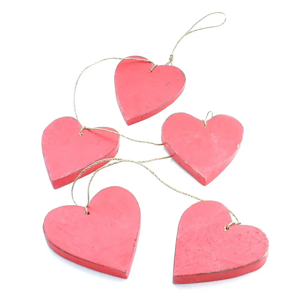 Set of five hanging wooden heart string decorations, natural wood finish, perfect for home decor by Suzie Blue Canada.