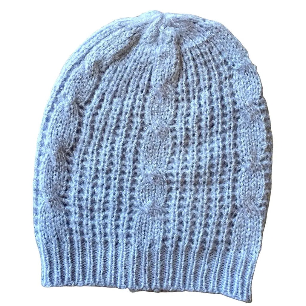 Cable knit hat by Suzie Blue Canada, featuring a cozy, stylish design perfect for warmth and fashion in cold weather.
