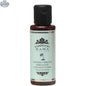 Extra virgin organic coconut oil from Kama Ayurveda, shown in a clear container, ideal for skin and hair care.