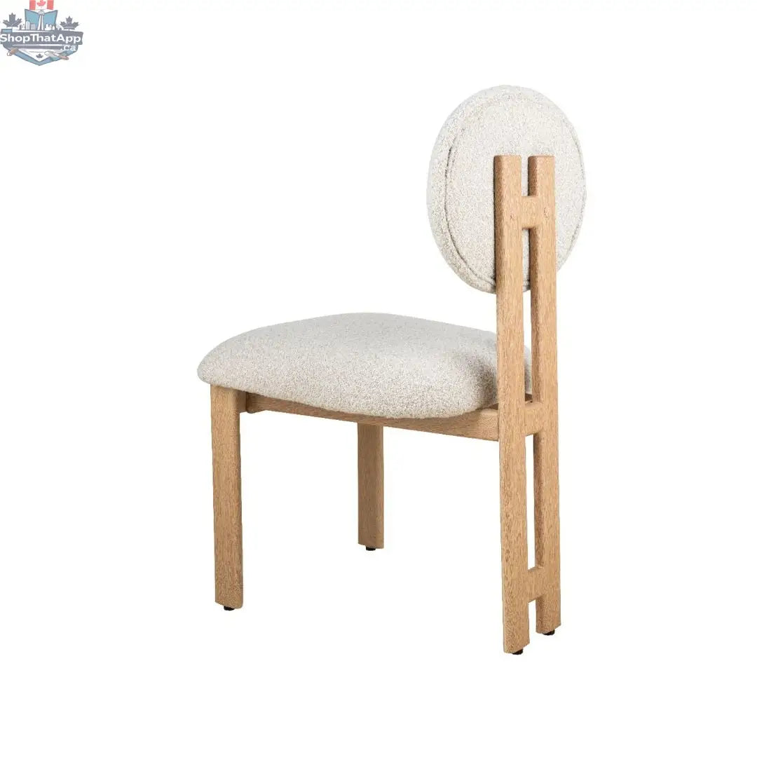 Hygge Design House Tova dining chair with wooden legs and upholstered seat, modern Scandinavian style, shown from side angle.