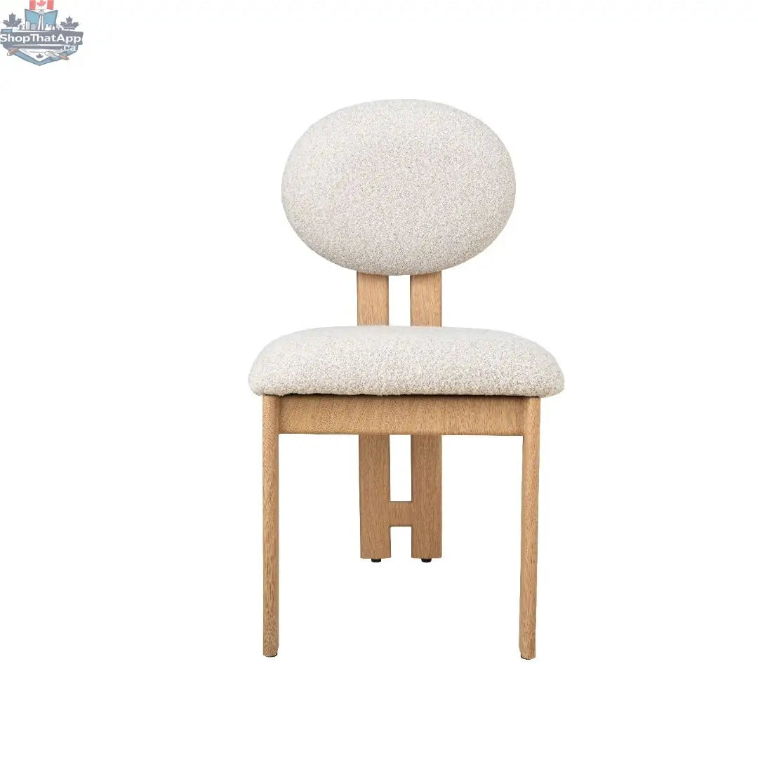 Hygge Design House Tova Dining Chair with wooden legs and upholstered seat, modern Scandinavian style, in a cozy dining room setting.