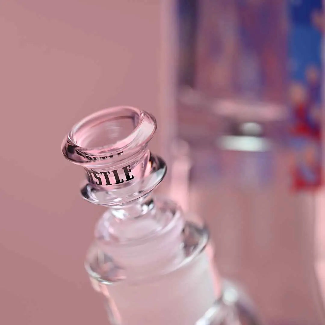 Close-up of Castle Glassworks 18-inch alien-shaped beaker bong with 9mm thick glass on a pink background.