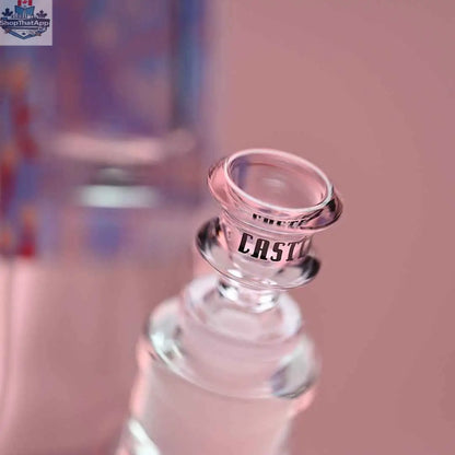 Close-up of 18-inch Alien beaker bong by Castle Glassworks, featuring pink background and detailed glass bowl.