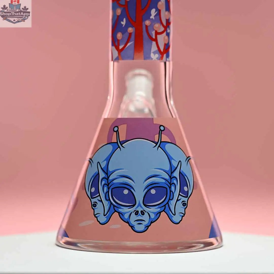 18-inch Alien beaker bong by Castle Glassworks with 9mm thick glass and pink background, close-up of the base showing intricate design.