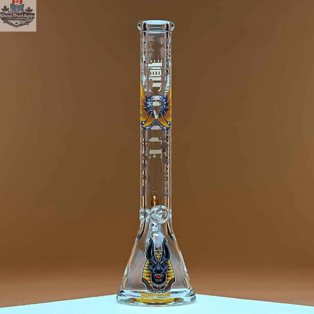 18-inch Castle Glassworks Anubis beaker bong with 9mm thick glass and detailed Anubis design on an amber background