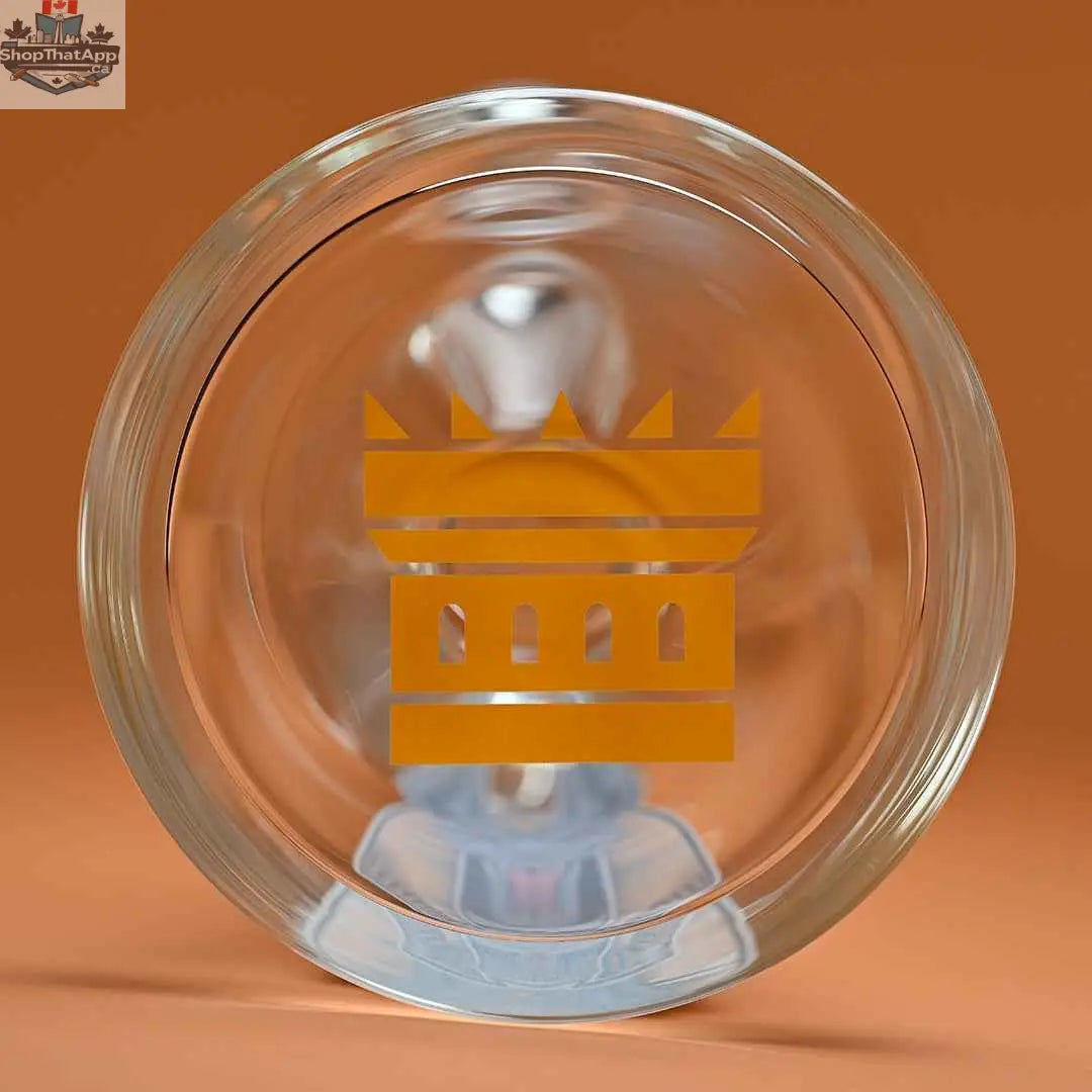 Close-up of Castle Glassworks 18-inch Anubis beaker bong with 9mm thick glass, showing the base with amber background.