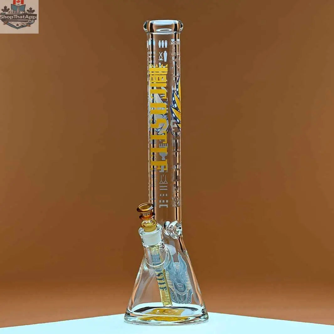 Castle Glassworks 18-inch Anubis beaker bong made of 9mm thick glass with an amber background, showcasing its sturdy design.