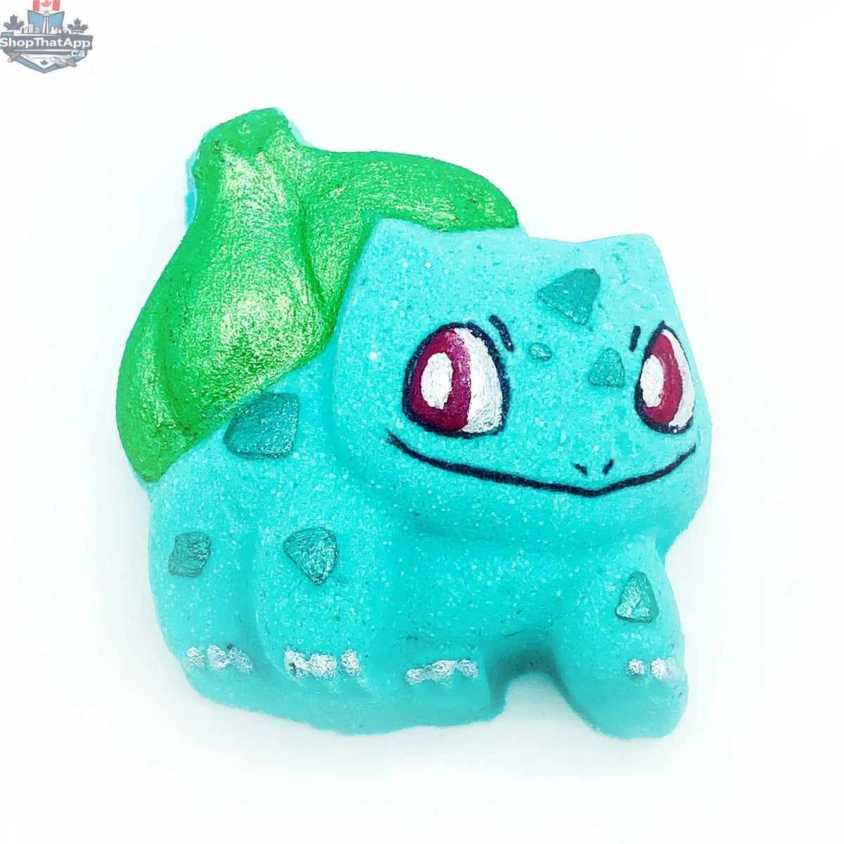 Bath bomb featuring Bulbasaur design from The Bomb Bar Canada, designed to enhance health and wellness with colorful, playful elements.