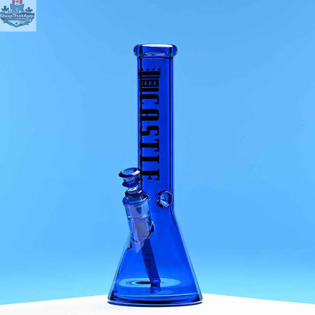 Blue 14-inch beaker bong by Castle Glassworks with heavy-duty electroplated glass, showcased against a blue background.