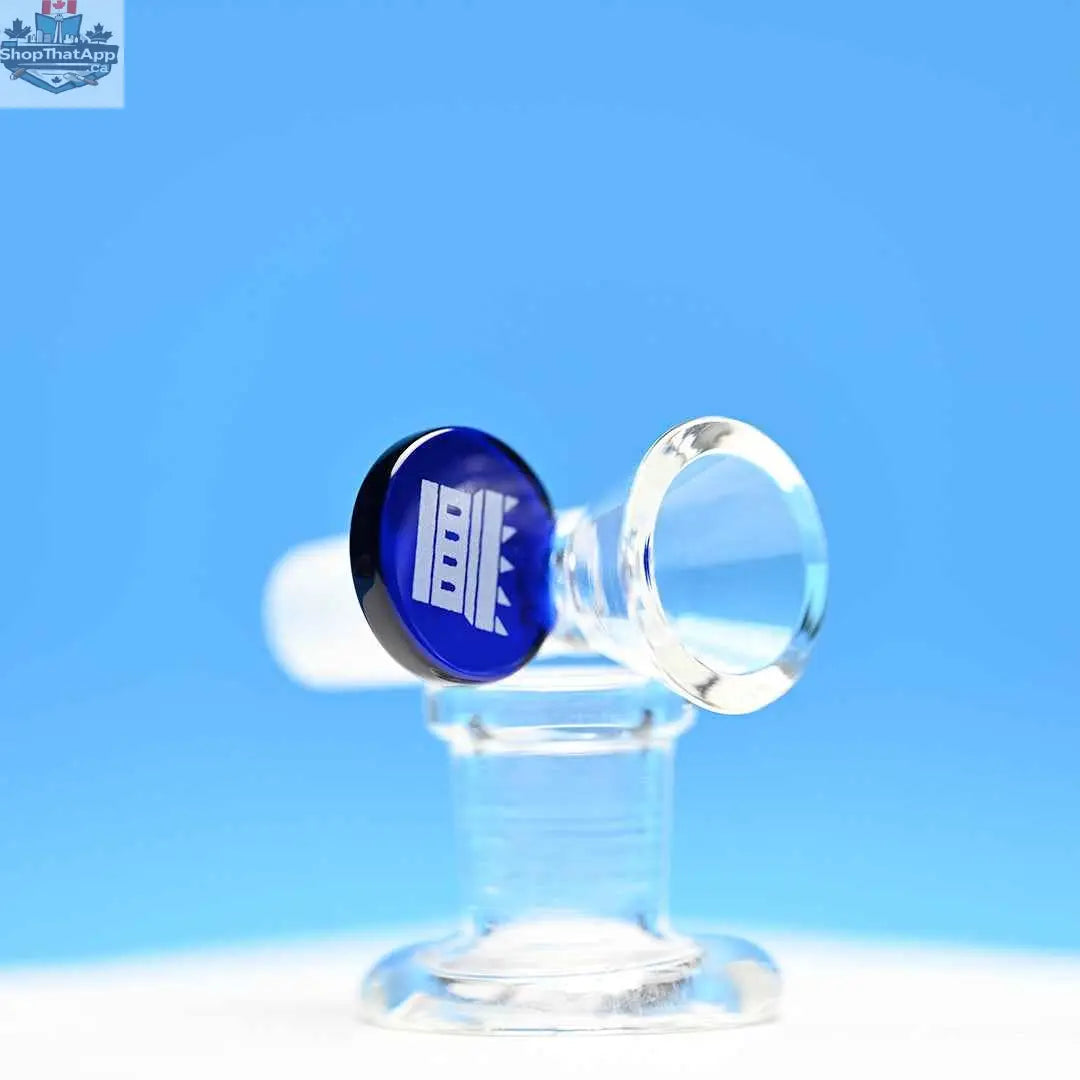 Blue 14mm borosilicate glass round tab bowl piece by Castle Glassworks on a blue background, showing the clear, smooth glass bowl.