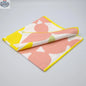 Set of four printed cotton celebration dinner napkins in blush and yellow with festive designs by Hem And Tassel.