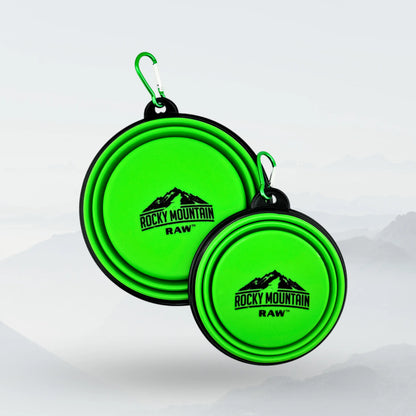 Green foldable dog bowl by ROCKY MOUNTAIN RAW, lightweight and portable for pets, shown unfolded with a pet-friendly design.
