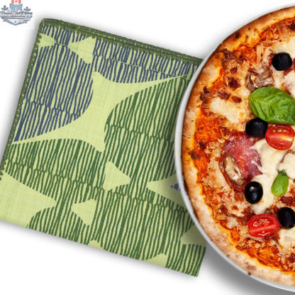 Green printed cotton dinner napkin with pizza design from Hem And Tassel for celebration dinners.