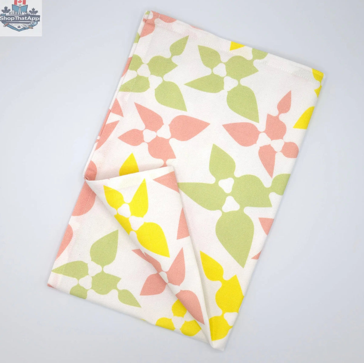 Hem and Tassel Celebration Cotton Printed Tea Towel in blush, folded flat, featuring festive design for kitchen use