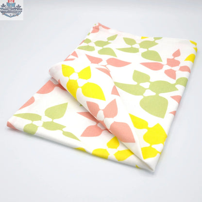Hem And Tassel Celebration Cotton Tea Towel with blush celebration design, folded to show printed kitchen towel for festive occasions.