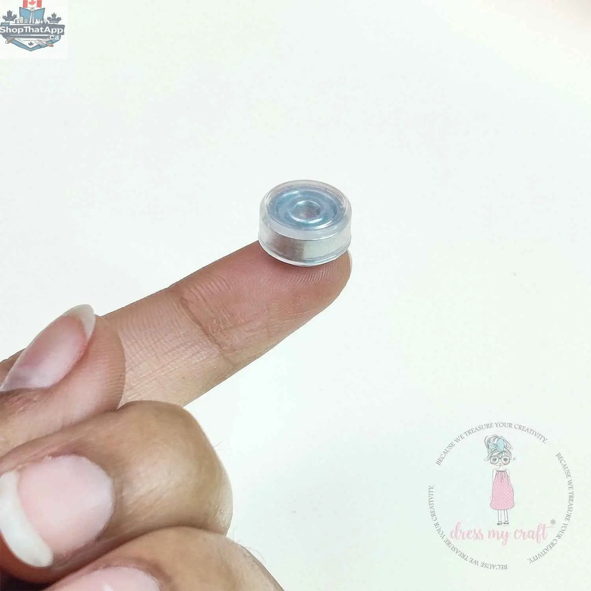 Clear Dress My Craft transparent spinner embellishments by Ecstasy Crafts, shown in a close-up image.