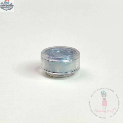 Transparent spinners embellishments by Dress My Craft for craft projects, featuring clear, shiny decorative accents from Ecstasy Crafts.