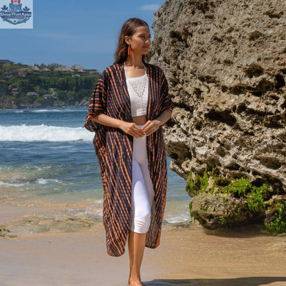 Orange and black tie-dye long kimono from Suzie Blue Canada, featuring a stylish, flowy design perfect for casual or boho outfits.