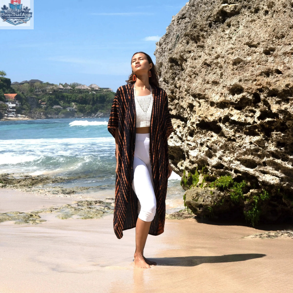 Orange and black tie-dye kimono by Suzie Blue Canada featuring long, flowing fabric and stylish design.