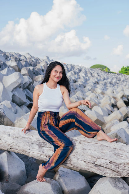 Navy gold tie dye pants by Suzie Blue Canada featuring abstract Bali style and comfortable fit, shown on a model.