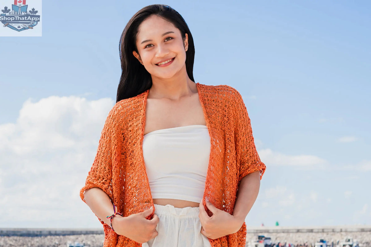 Orange mid-length popcorn knit kimono by Suzie Blue Canada, featuring a soft, textured knitwear design and relaxed fit.
