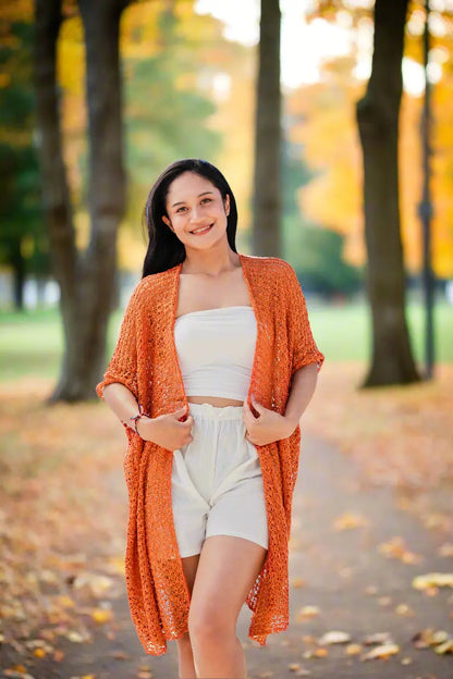 Orange mid-length popcorn knit kimono by Suzie Blue Canada, featuring a cozy and stylish knitwear design with a relaxed fit.
