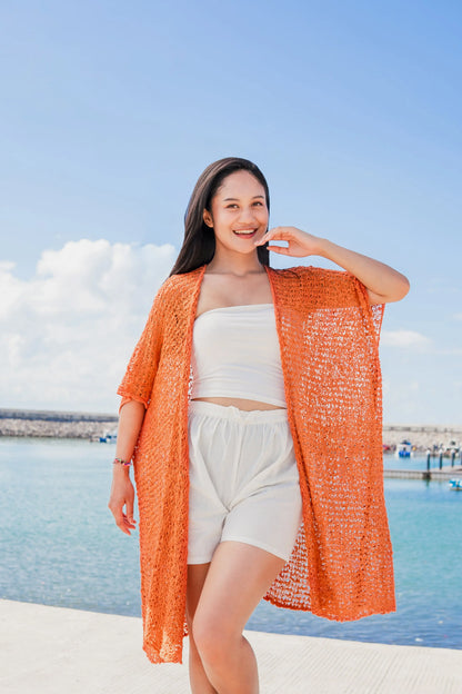 Orange mid-length popcorn knit kimono by Suzie Blue Canada, showcasing its textured knitwear and relaxed fit.