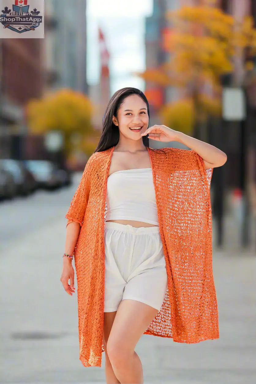 Orange mid-length popcorn knit kimono by Suzie Blue Canada, showcasing its cozy, textured knitwear design.