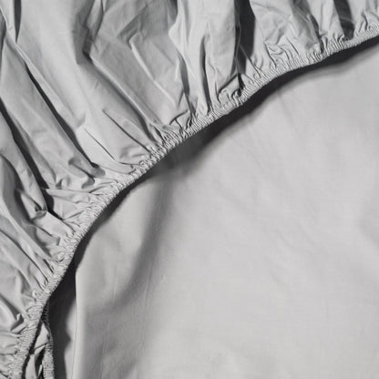 Organic percale fitted sheet by Skylark+Owl Canada, shown on a bed, highlighting its smooth, crisp fabric and tailored fit.