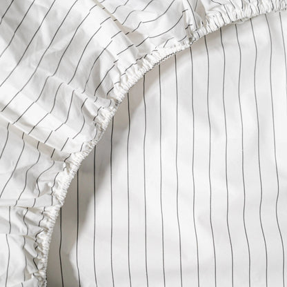 Organic percale fitted sheet by Skylark+Owl Canada, showing smooth, crisp fabric with elastic edges for a snug, comfortable fit.