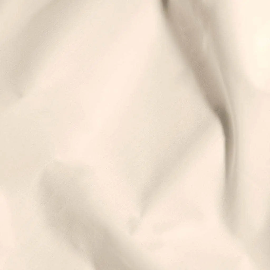 Soft beige organic percale sheets from Skylark+Owl Canada, featuring a smooth, textured dune-inspired fabric in a luxurious sheet set.