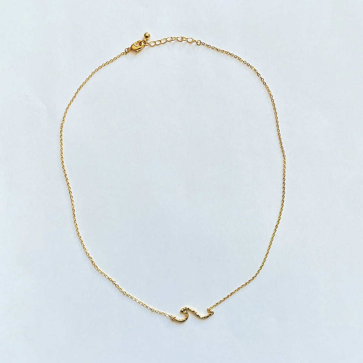 Gold-plated Chainlink Necklace with wave pendant by Suzie Blue Canada, featuring a stylish and elegant chain design.