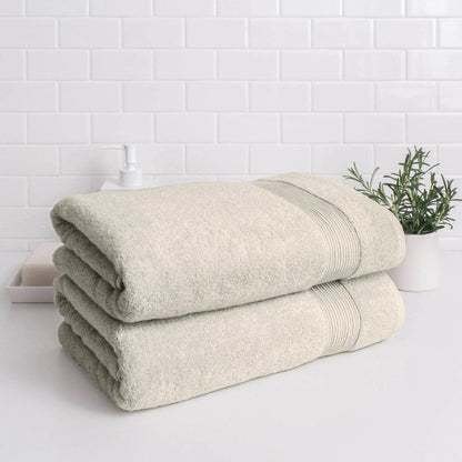 Stack of Essence Turkish Bath Towels by Skylark+Owl Canada, showcasing plush, absorbent white bath sheets folded neatly.