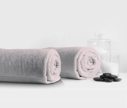 Light grey Essence Turkish bath towel rolled up, showcasing its luxurious, absorbent design by Skylark+Owl Canada.